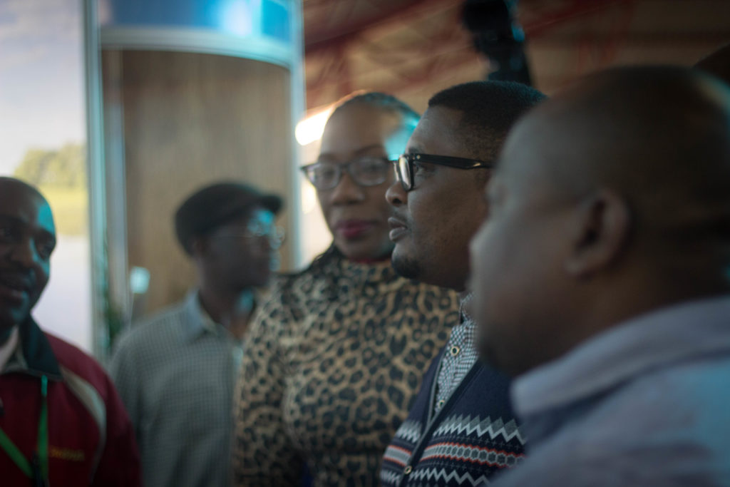 An Exhibitor talks with Minister of tourism Walter Mzembi at their stand